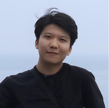A person smiling in front of a white buildingAI-generated content may be incorrect.